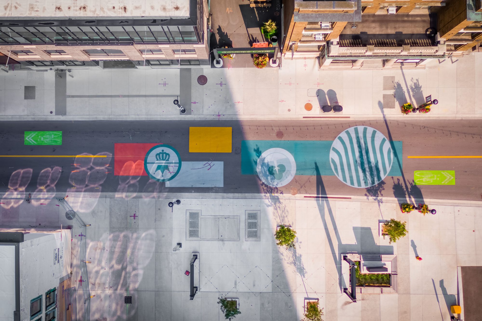 Aerial view overlooking intersection with colorful bold ground surface treatment.