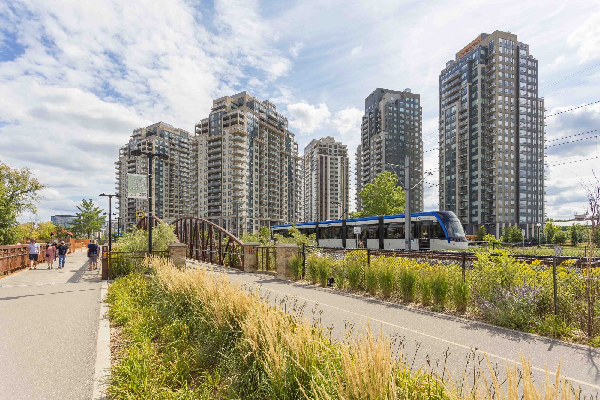 The ION Light Rail Transit train passes by the Barrel Yards residential complex in Uptown Waterloo.