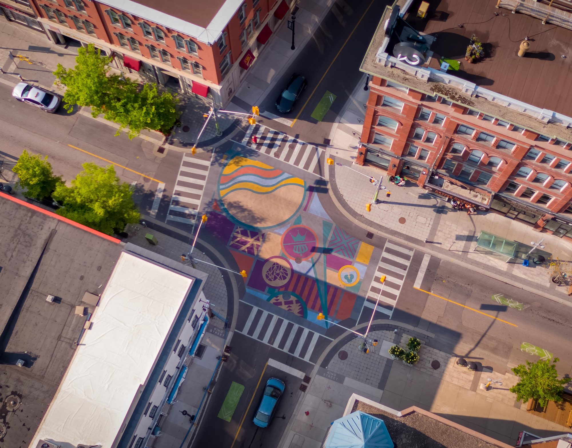 Aerial view overlooking intersection with colorful bold painting on the ground