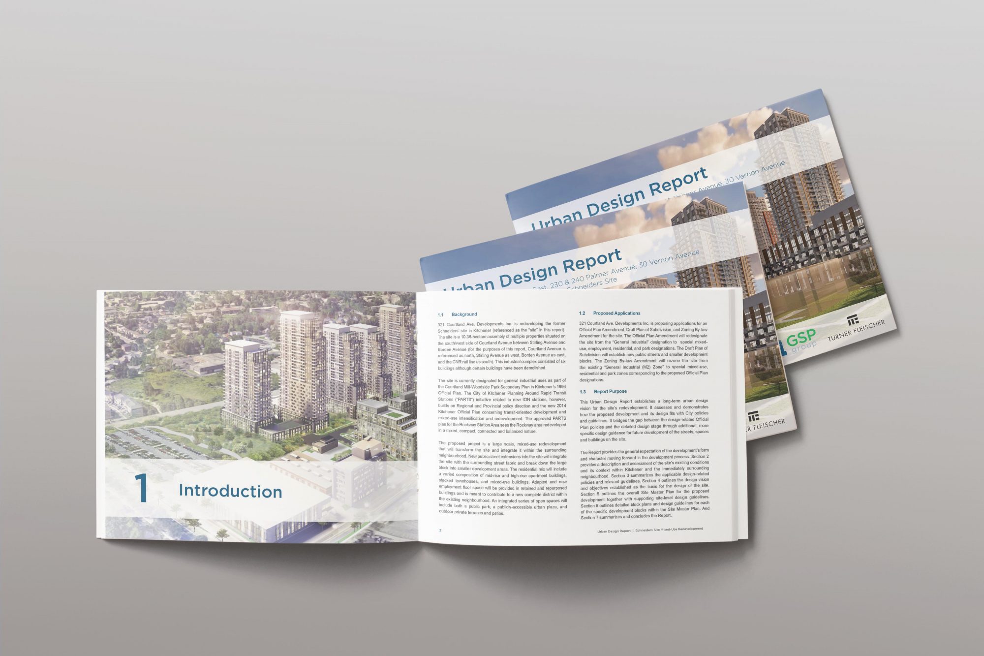 A report is open to the introduction page. This report is sitting on top of two identical reports that have “Urban Design Report” written across the cover.