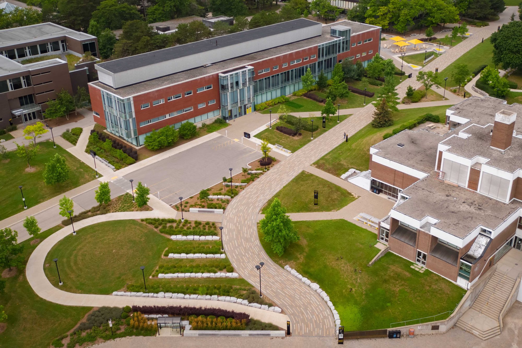 Aerial view of the University of Waterloo campus grounds showing path towards the South Common area via linear interlocked paving.