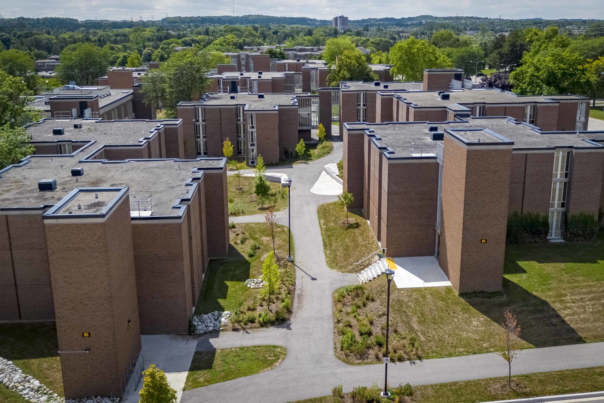 Aerial view of a cluster of student residential buildings on the grounds of the University of Waterloo.